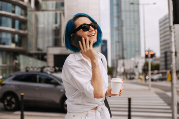 Fototapeta premium Portrait of beautiful casual women walking outside her office.