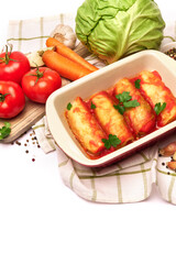 cabbage rolls stuffed with ground beef and rice with sour cream in a baking dish and ingredients