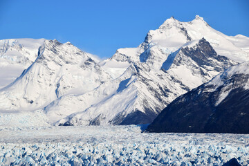 Perito Moreno glacier in a beautiful sunny day, showing blue ice in contrast with white snow, Argentina