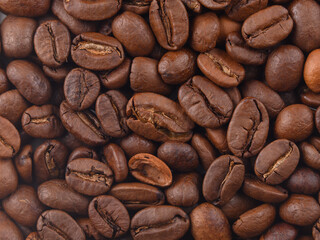Coffee texture beans macro under hard light. Photo horizontal HD