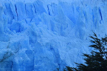 Perito Moreno glacier in a beautiful sunny day, showing blue ice in contrast with white snow, Argentina