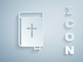 Paper cut Holy bible book icon isolated on grey background. Paper art style. Vector