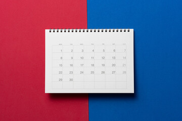 close up of calendar on the red and blue table background, planning for business meeting or travel planning concept - obrazy, fototapety, plakaty