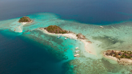 aerial view tropical island with sand white beach. Bulog Dos, Philippines, Palawan. Seascape bay with turquoise water and coral reef.