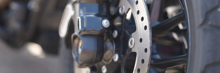 Closeup of metal brake disc on motorcycle wheel © H_Ko