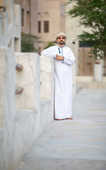 Arab man looking at the sunrise in the alleys of al seef district in Dubai