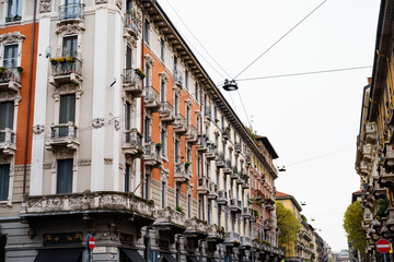 Fototapeta na wymiar Carved stone balconies on the facade of the building. Milan, Italy