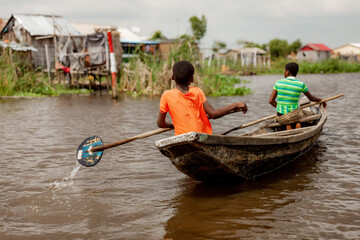 Girl rowing in Ganvié, Benin on Lake Nokoue. 