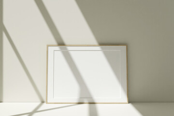 Horizontal wooden photo frames mockup on the floor leaning against the room wall with shadow
