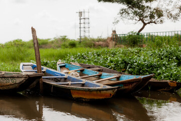Pirogues or boats on Lake Nokoue parked at market for the day in Benin, Africa. 