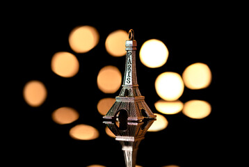 Figure of the Eiffel Tower on the background of lights