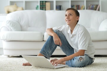 Fototapeta premium boy using modern laptop at home