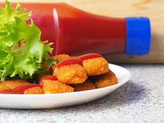 fish sticks chicken sticks breaded nuggets with ketchup and lettuce