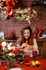 A beautiful girl portrait in a Christmas interior. Christmas tree, decorated fireplace, lots of gifts, Christmas theme. Cozy atmosphere.