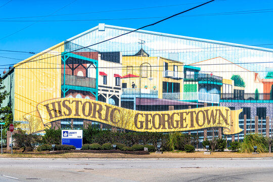 Georgetown, USA - February 3, 2021: Building with colorful mural sign facade for historic city town and Liberty Steel in South Carolina