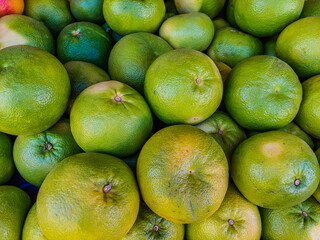 green tangerines on the market