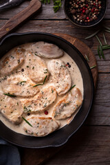 Cooked chicken breast with creamy sauce in frying pan