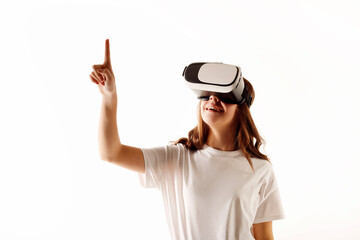 Young teenager girl wearing virtual reality goggles over white background. 3D virtual lifestyle concept.