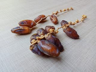 Deglet Nour Dates or Royal Dates or Dates Fruits or Phoenix dactylifera, attached on the stem