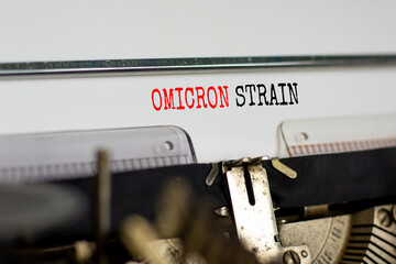 Covid-19 new omicron virus variant symbol. Concept words Omicron strain typed on retro typewriter....
