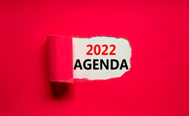 2022 agenda new year symbol. Words '2022 agenda' appearing behind torn pink paper. Beautiful pink background. Business, 2022 agenda new year concept, copy space.