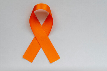 orange ribbon, symbol of the fight against skin cancer, melanoma, orange December