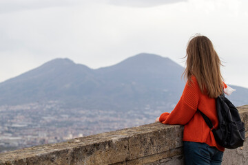 Woman tourist in Naples. Looks at the Mount Vesuvius.