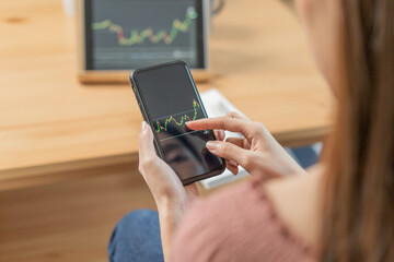 Investor analyzing exchange market, asian young business woman, girl trader on graphic charts on...