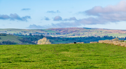 A view across farmland around the village of Wetton, UK on a sunny Autumn day
