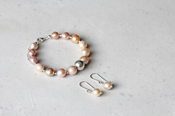 Bracelet, earrings Kasumi pearls . A bracelet made of on a hand from natural stone Kasumi pearls. Bracelet, earrings made of natural pearls. Handmade jewelry. Jewelry set bracelet and earrings