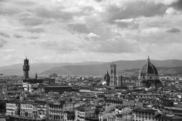 Beautiful monochrome panoramic view of Florence in a sunny day with clouds. Italian panorama of a city in Tuscany. Top aerial landscape view of an ancient historical tourist destination in Europe.