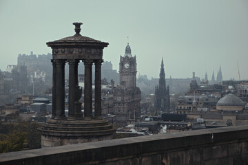 Top view of Edinburgh city centre in Scottish cloudy foggy weather. Cityscape of the monument to Dugald Stewart, Edinburgh, Scotland, United Kingdom