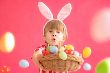 Surprised child holding basket with Easter eggs