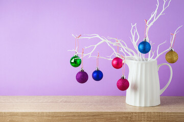 Christmas holiday creative decoration on wooden shelf over violet background
