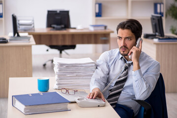 Young male employee working in the office