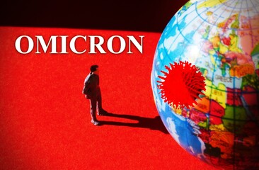 Miniature Man observing the planet earth with the Omicron new variant Virus in a red background.