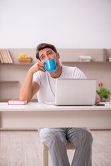 Young male employee working from home during pandemic