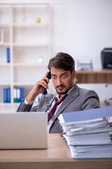 Fototapeta premium Young male employee working in the office
