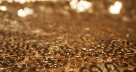 abstract textile background. detailed extreme close-up of gold sequins on fabric