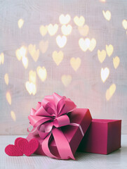 Valentines day concept with gift box over heart shaped bokeh.