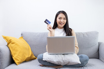 Woman Holding Credit Card in Front of Her Laptop For Onlie Shopping