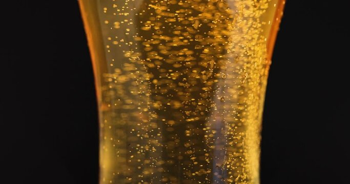 Closeup of glass with cold beer and bubbles 4k movie slow motion