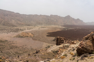 The lava fields of Las Canadas caldera of Teide volcano and rock formations - Roques de Garcia. Tenerife. Canary Islands. Spain.