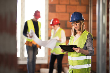 worker, investor, inspector or architect with tablet. construction site engineers on site.