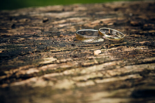 Close-up of wedding rings on uniform texture