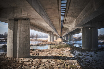 View under the motorway bridge. The river also flows under the bridge