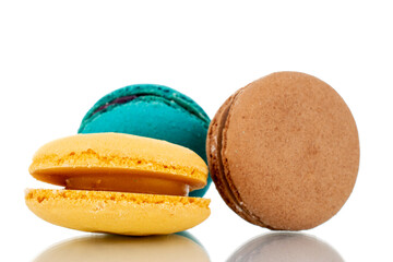 Three sweet macaroons, close-up, isolated on white.