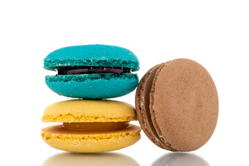 Three sweet macaroons, close-up, isolated on white.