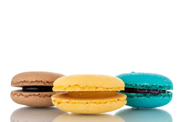 Three sweet macaroons, close-up, isolated on white.