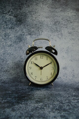 old alarm clock on the gray background